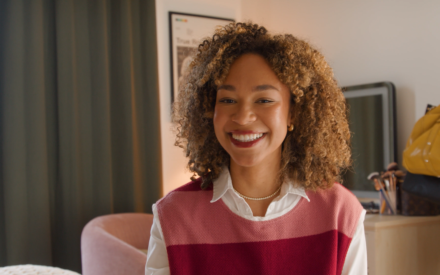 A woman smiling sitting in front of her computer