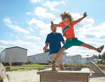 Jumping for joy on holiday at Hopton Holiday Park, Norfolk.