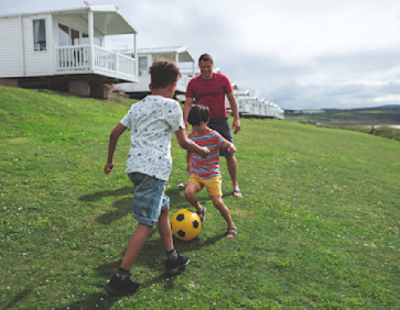 Boys playing outside the caravan