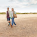 Couple walking their dog along the beach