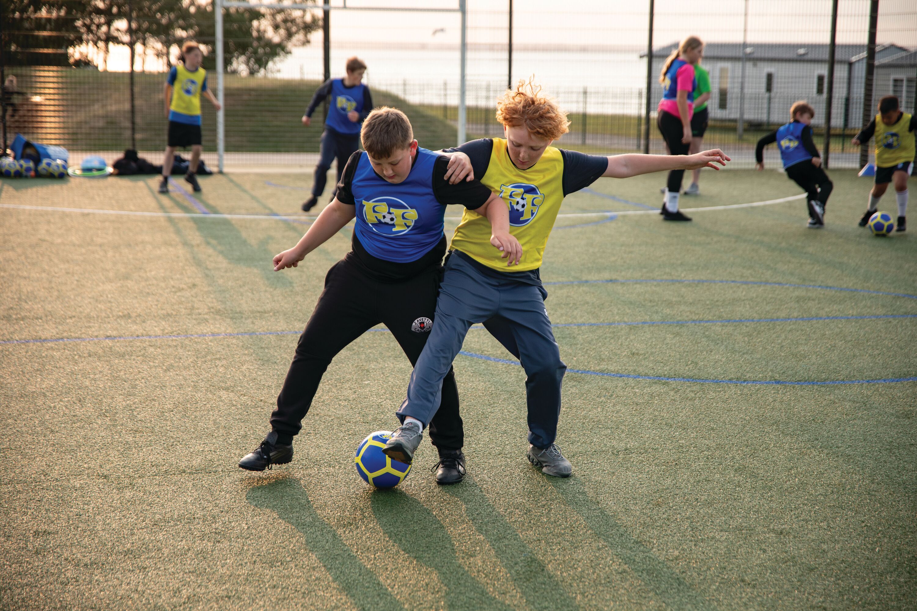 Children between 5-12 years playing football together with Football Fun Factory.