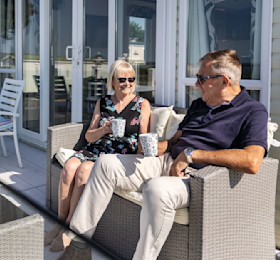 Drinking a hot drink on the caravan deck