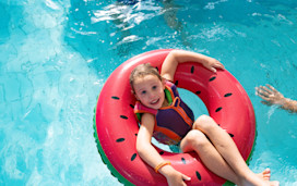 A young girl floats on a doughnut in one of Haven's indoor pools.
