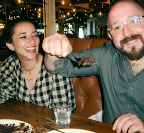 A couple enjoying food and drink at a Haven restaurant