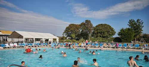 Outdoor pool and the sunloungers around the pool edges.