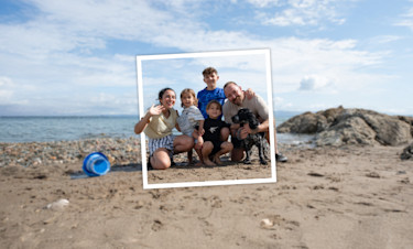 Family posing for a photograph on the beach