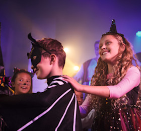 Kids dance around together at Haven in their finest Halloween fancy dress outfits.