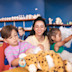 A tot and older child enjoy getting creative in a Make a Bear session at Haven.