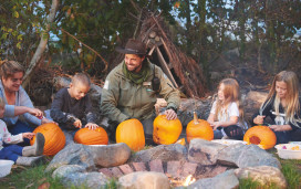 Kids carving pumpkins at Halloween
