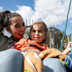 A mother and son on a swing at a Haven park playground.