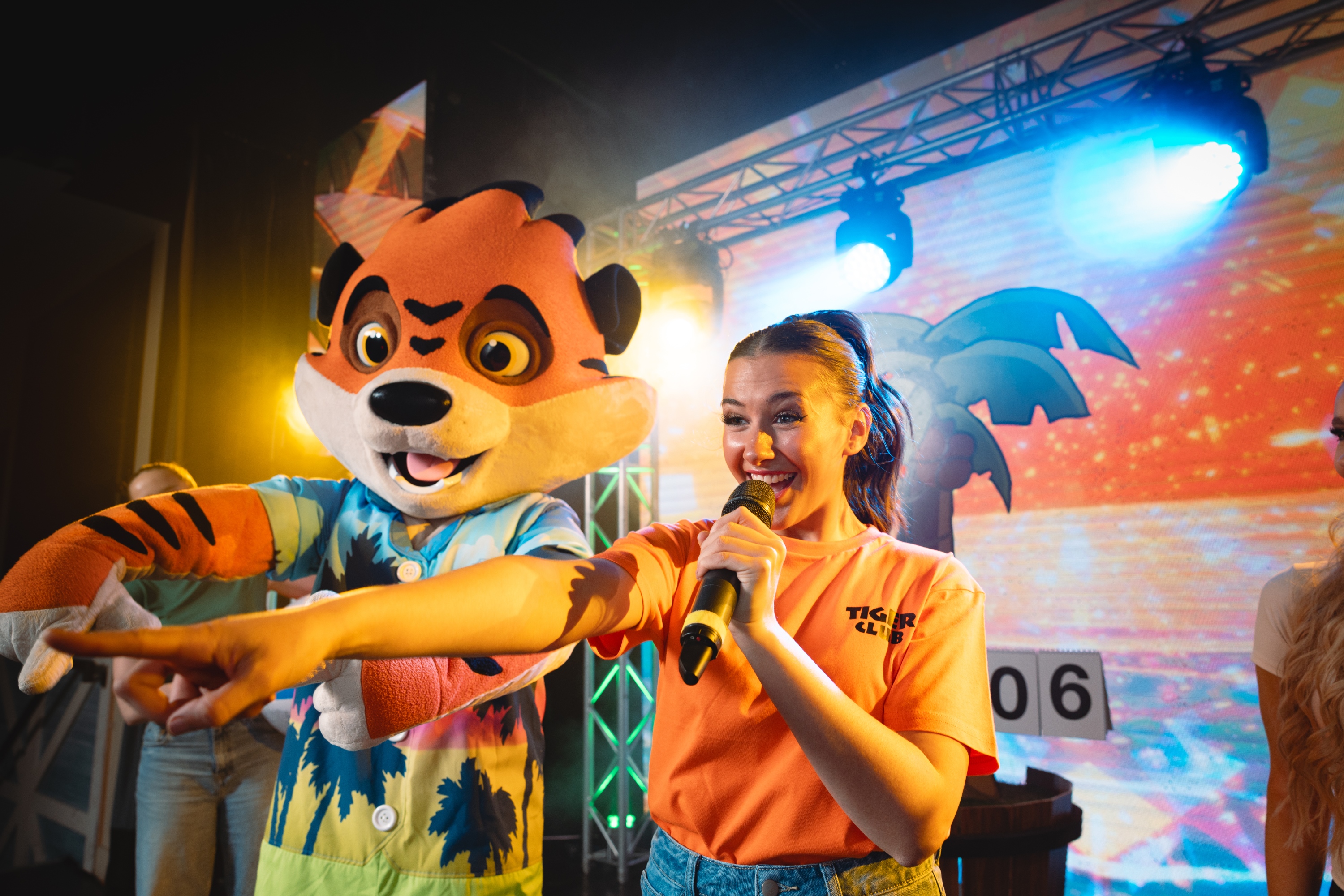 Rory and an entertainment team member on stage for the Tiger Club.