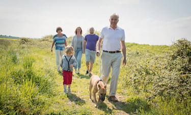 Family walking the dog at the nature reserve