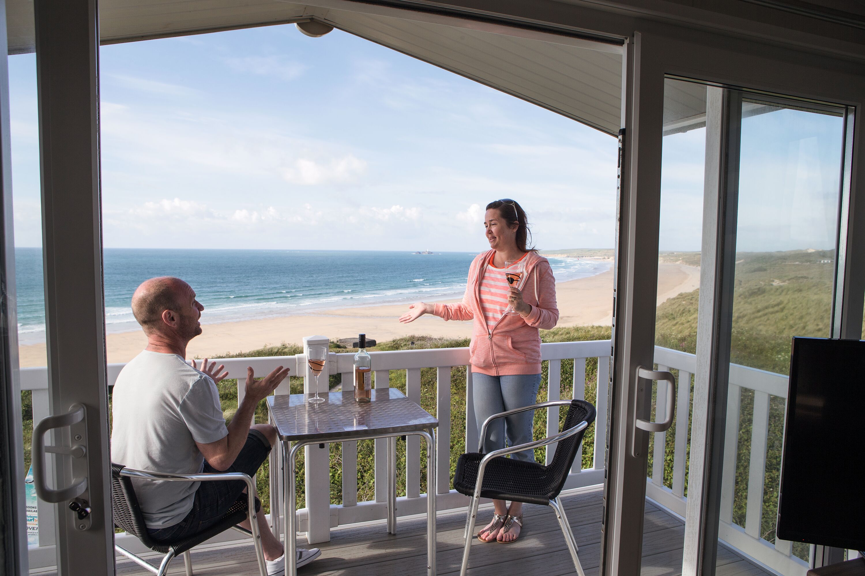 couple in silver caravan on decking