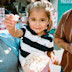 A tot enjoys popcorn and ice cream in the sunshine.