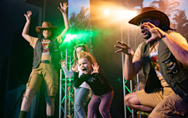 Two young children join in on-stage in a Dinosaur Detectives entertainment session at Haven.