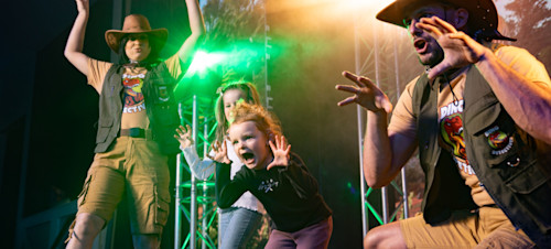 Two young children join in on-stage in a Dinosaur Detectives entertainment session at Haven.