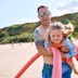 A Dad and daughter play together on the beach.
