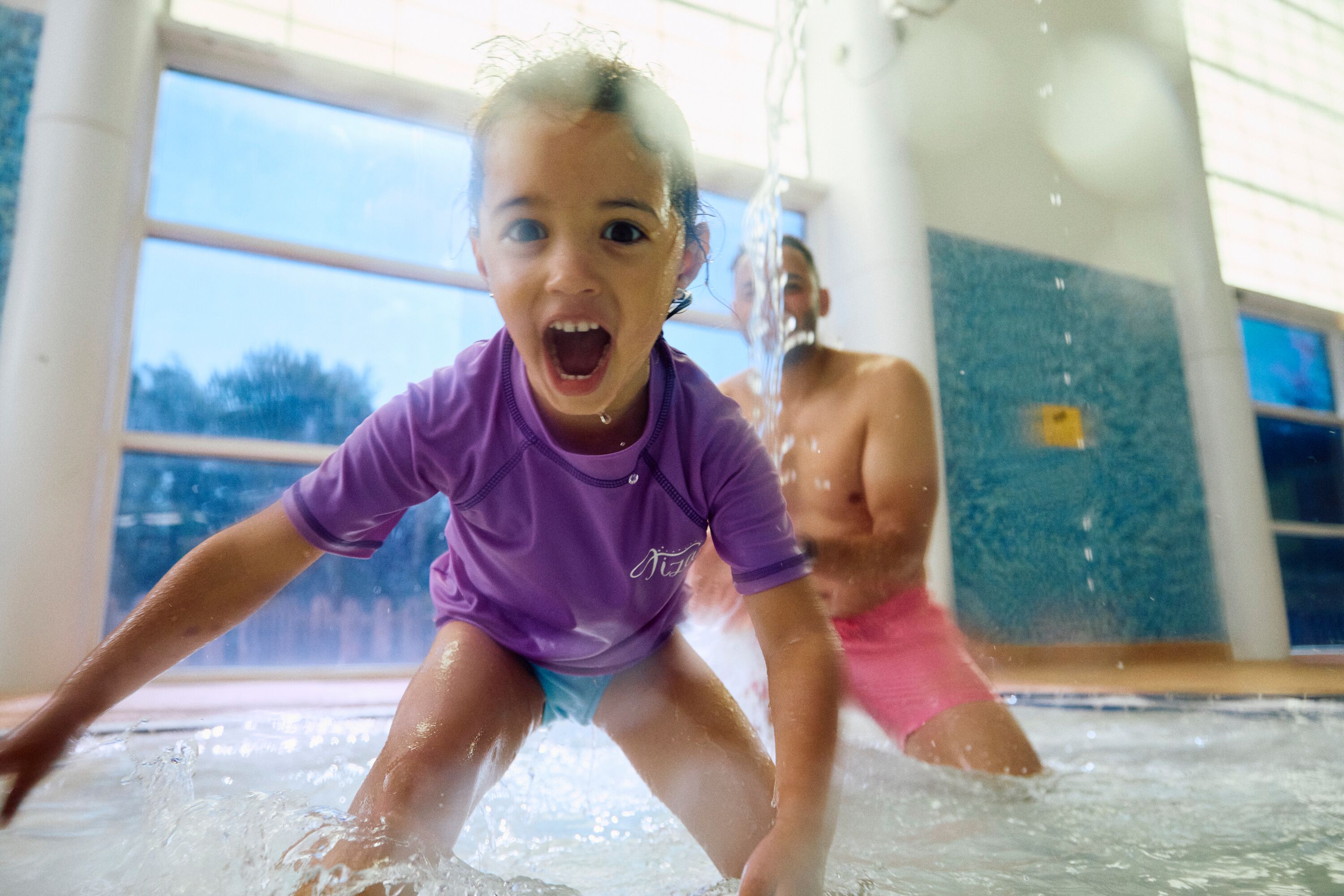 A dad and daughter play together in the pool at Primrose Valley, Yorkshire.