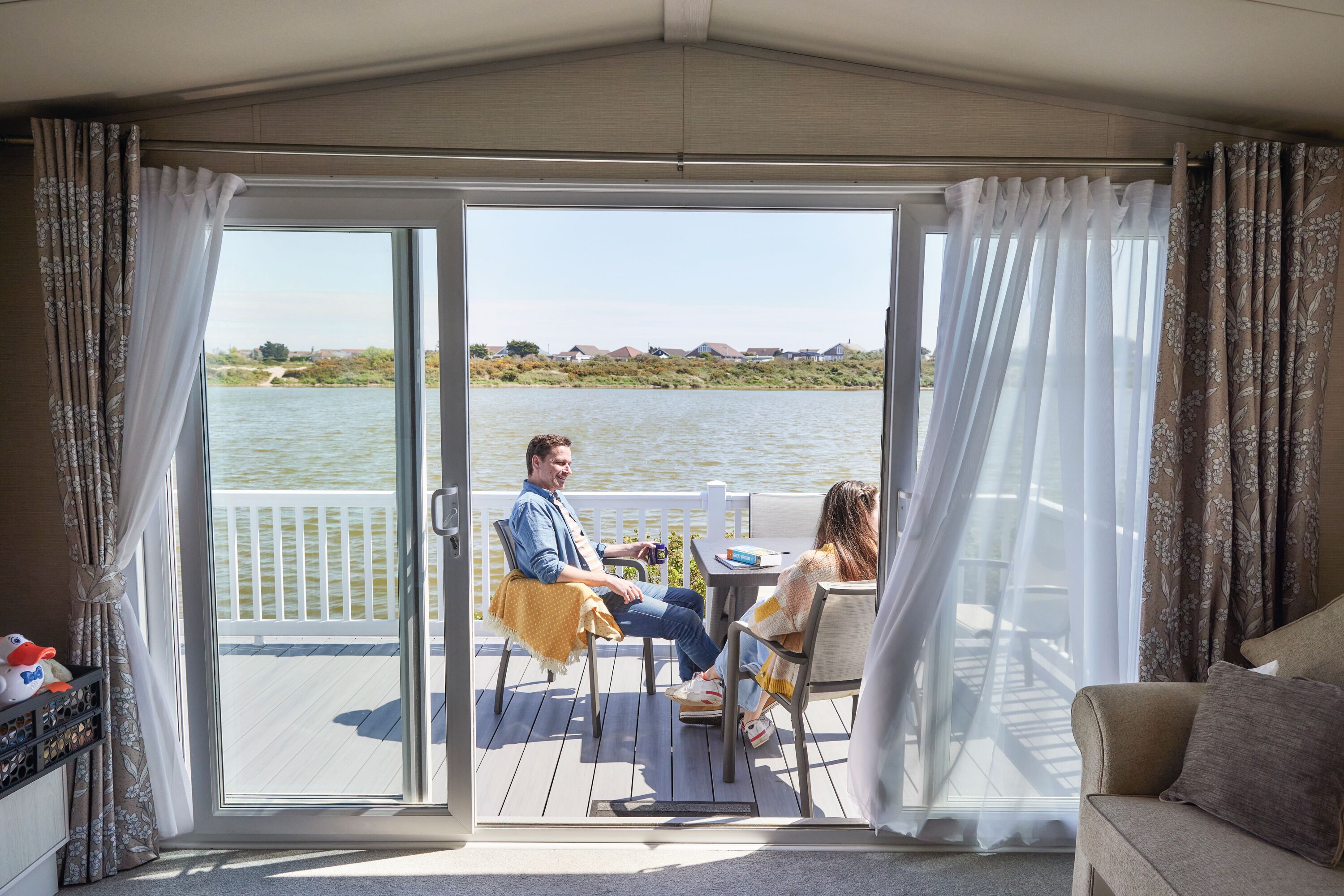 The owners' relaxing on the deck of their caravan
