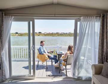 The owners' relaxing on the deck of their caravan