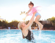 A mum and her young daughter enjoy the owners exclusive outdoor pool at Greenacres, North Wales.