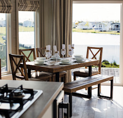 Looking out onto one of Haggerston Castle's lakes from inside a lodge holiday home.