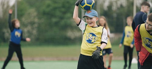 Children between 5-12 years playing football together with Football Fun Factory.
