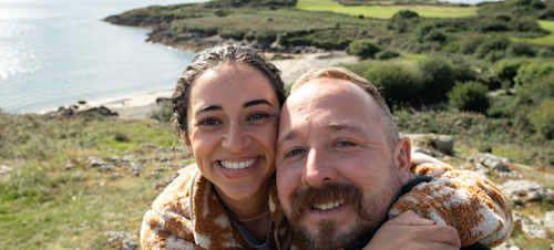 Couple taking a selfie at the sea near Hafan y Mor