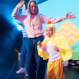 a mum and child on stage with the child dressed up as a chicken