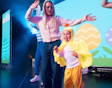 a mum and child on stage with the child dressed up as a chicken