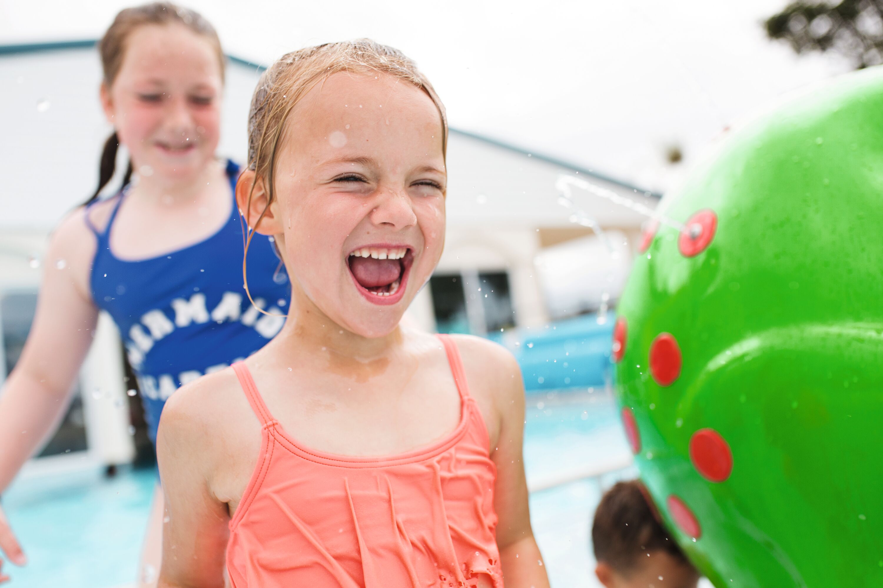Two girls enjoy the splash features at Doniford Bay Holiday Park, Somerset.