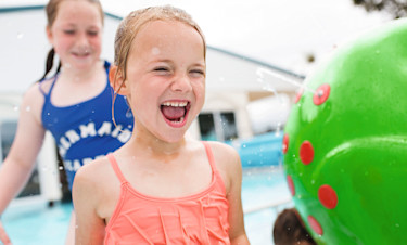 Two girls enjoy the splash features at Doniford Bay Holiday Park, Somerset.