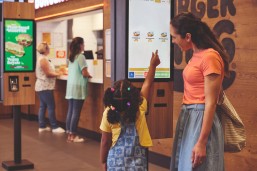 Family selecting their order on the screens at Burger King®