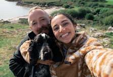 A couple with their dog on a walk