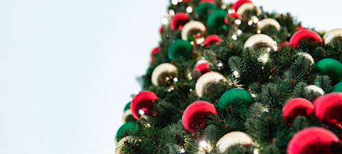 Baubles adorn a festive Christmas tree.