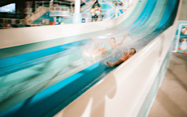 A pair of brothers race down the multi-lane slide at Hafan y Mor, North Wales.