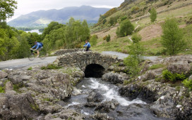 Cyclists crossing Ashness Bridge in the Lake District.