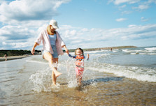 mum and tot in the sea on the beach
