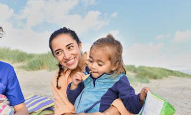 Toddler enjoying a beach with her mum at Haven