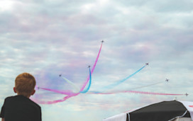 A young boy watches the Air Show over the skies in Blackpool.