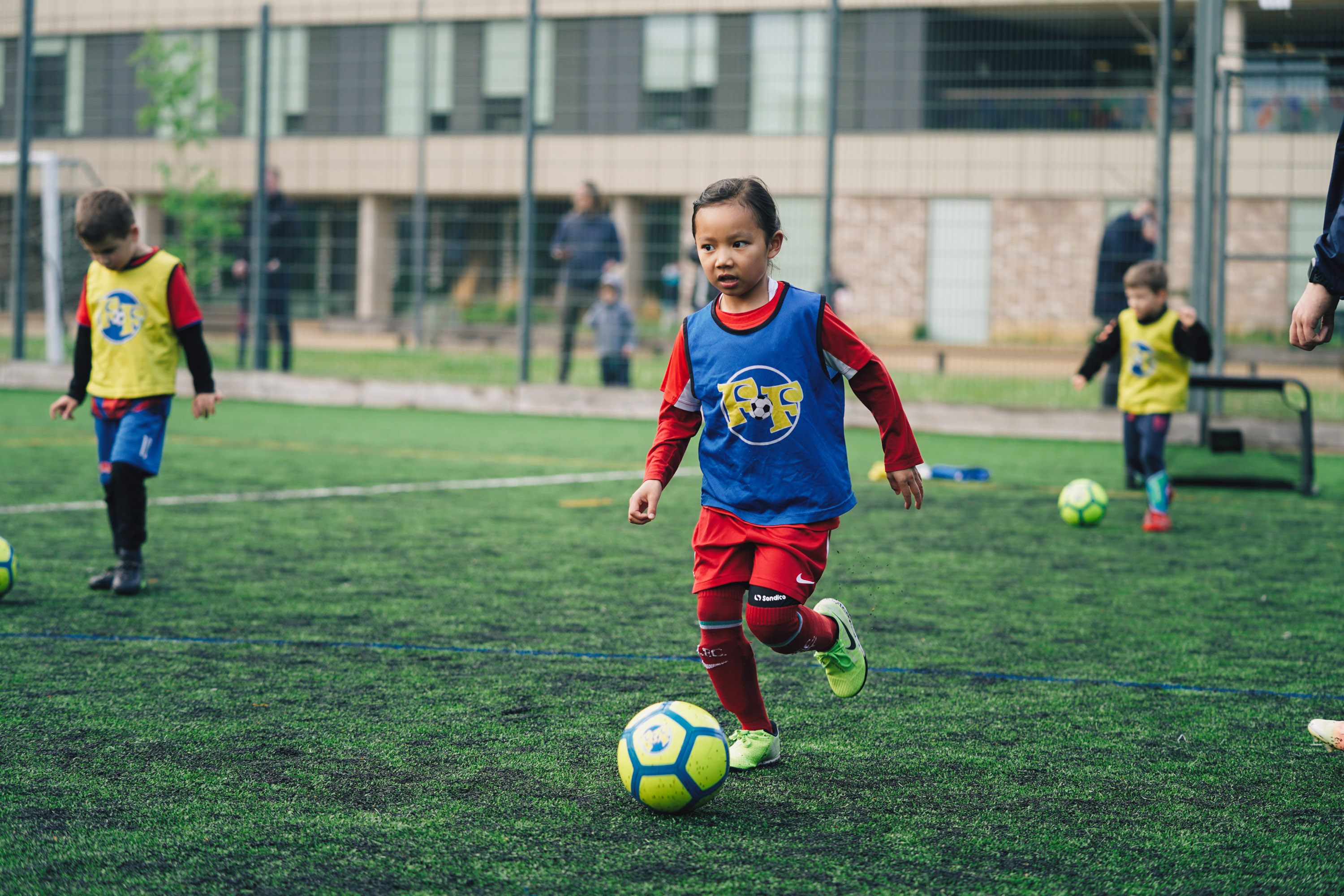 A girl playing football with Football Fun Factory.