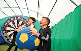 Chidren playing Football Fun Factory Dartboard challenge