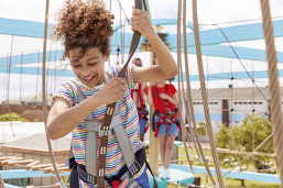 Teen on aerial adventure course at Golden Sands