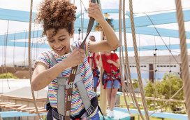 Teen on aerial adventure course at Golden Sands