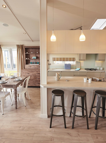 Representation of a dining area and a kitchen in a Signature Lake view lodge