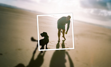 Man and his dog enjoying the beach