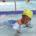 A child splashing around in the pool