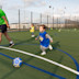 A young boy chases a football in a Footbal Fun Factory activity session at Haven Kent Coast.
