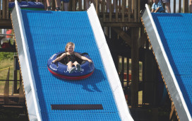 A young girl tries out the Tube Slide at Haven Devon Cliffs - a new activity for 2023