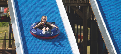 A young girl tries out the Tube Slide at Haven Devon Cliffs - a new activity for 2023